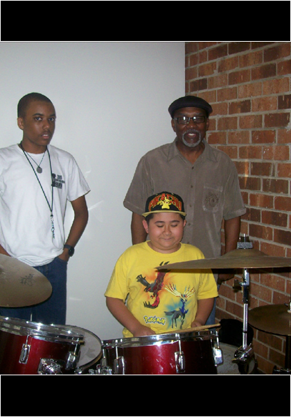 William "Rod" Garland, from the group Rebirth, and grandson, giving Jarred a few pointers on the drums!