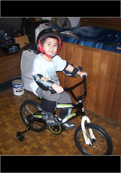 Christmas 2010! Jarred got his new bike and is all dressed up with no place to go! We got a white Christmas so I pulled the van outside so he would have somewhere to ride!