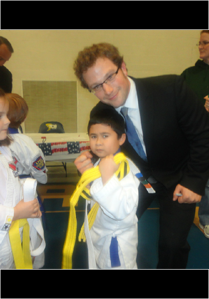 Jarred at Karate graduation, is presented with his Yellow Belt!