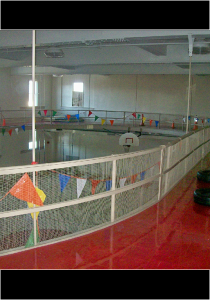Upstairs there was a indoor track for running. It is now a flat floor, and the spiral staircase leads downstairs!