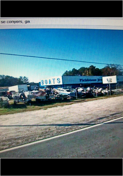 When the shooter in first girl speeds out of the boat lot, the sign says Covington 9 miles!